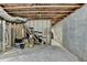 Unfinished basement with concrete floors, exposed ceiling, and wood framing at 2467 Sky Valley Dr, Dacula, GA 30019