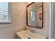 Charming half-bath featuring shiplap walls, a square mirror and a vanity sink at 2467 Sky Valley Dr, Dacula, GA 30019