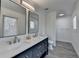 Bathroom with double sink, vanity, granite counters, and modern tile floors at 2467 Sky Valley Dr, Dacula, GA 30019