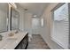 Bathroom featuring double sinks, elegant fixtures, and bright natural light at 2467 Sky Valley Dr, Dacula, GA 30019
