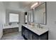 Bright bathroom featuring a dual sink vanity, two large mirrors, and a separate tub at 2467 Sky Valley Dr, Dacula, GA 30019