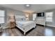 Bright bedroom featuring hardwood floors, a queen bed, and plenty of natural light at 2467 Sky Valley Dr, Dacula, GA 30019