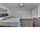 Bright bedroom with hardwood floors, a queen size bed, and a white door at 2467 Sky Valley Dr, Dacula, GA 30019