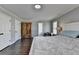 Bedroom featuring hardwood floors, a queen bed, and a wooden dresser at 2467 Sky Valley Dr, Dacula, GA 30019