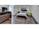 Bedroom featuring a comfortable queen bed, hardwood floors and a dresser at 2467 Sky Valley Dr, Dacula, GA 30019