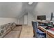 Cozy bonus room with a couch and desk area, perfect for relaxation and work at 2467 Sky Valley Dr, Dacula, GA 30019