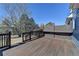 An outdoor deck featuring brown wood, black railings, and a partial view of the backyard at 2467 Sky Valley Dr, Dacula, GA 30019