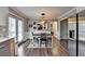 This is a dining room with decor, dining table, and stainless steel fridge at 2467 Sky Valley Dr, Dacula, GA 30019