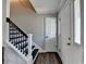 Welcoming foyer with dark wood floors and a staircase, showcasing a blend of modern design at 2467 Sky Valley Dr, Dacula, GA 30019