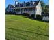 Traditional two-story home featuring a covered front porch and lush green lawn at 2467 Sky Valley Dr, Dacula, GA 30019