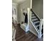 Hallway featuring built in storage and seating and a staircase with metal balusters at 2467 Sky Valley Dr, Dacula, GA 30019
