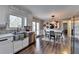Modern kitchen with stainless steel sink, white countertops, and dining area at 2467 Sky Valley Dr, Dacula, GA 30019