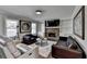 Comfortable living room features a stone fireplace, built-in shelves, and an abundance of natural light at 2467 Sky Valley Dr, Dacula, GA 30019
