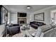 Inviting living room featuring a stone fireplace, modern furnishings, and bright natural light at 2467 Sky Valley Dr, Dacula, GA 30019