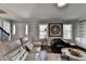 Bright living room with stylish furnishings, hardwood floors, and an adjacent staircase at 2467 Sky Valley Dr, Dacula, GA 30019