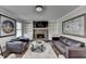 Cozy living room with a stone fireplace, built-in shelves, and comfortable seating at 2467 Sky Valley Dr, Dacula, GA 30019