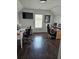 Bright office space with two desks, TV, large window, and hardwood flooring at 2467 Sky Valley Dr, Dacula, GA 30019