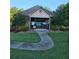 Community pool house surrounded by lush landscaping and well-manicured lawns in a residential area at 2467 Sky Valley Dr, Dacula, GA 30019