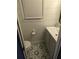 Charming powder room featuring white shiplap walls and floral mosaic tile floor at 2467 Sky Valley Dr, Dacula, GA 30019