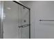 Shower featuring white subway tile, glass doors, and a sleek chrome fixture at 2467 Sky Valley Dr, Dacula, GA 30019