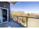 A balcony featuring glass railings that offers a view of lush trees on a clear day at 130 Arizona Ne Ave # 302, Atlanta, GA 30307