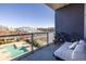 Relaxing condo balcony features a daybed, bike and view of community pool at 130 Arizona Ne Ave # 302, Atlanta, GA 30307