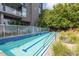 An outdoor pool surrounded by lush landscaping and modern building architecture at 130 Arizona Ne Ave # 302, Atlanta, GA 30307
