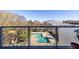 A relaxing view of a community pool from a balcony with glass railings and trees at 130 Arizona Ne Ave # 302, Atlanta, GA 30307