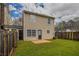 Backyard of a two-story house with a well-maintained lawn and wooden fence at 201 Coral Cir, Mcdonough, GA 30253