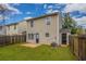 Backyard of a two-story house with a well-maintained lawn and wooden fence at 201 Coral Cir, Mcdonough, GA 30253