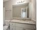 Bathroom featuring granite countertop, white cabinetry, and a large mirror at 201 Coral Cir, Mcdonough, GA 30253