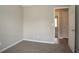 Empty bedroom offers neutral walls and carpet with a view to the hall at 201 Coral Cir, Mcdonough, GA 30253