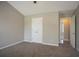 Neutral bedroom with plush carpet flooring and white closet doors at 201 Coral Cir, Mcdonough, GA 30253