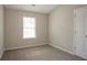 Neutral bedroom features plush carpet, a large window, and neutral paint at 201 Coral Cir, Mcdonough, GA 30253