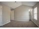 Neutral bedroom with plush carpet flooring and access to bathroom at 201 Coral Cir, Mcdonough, GA 30253