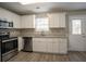 Well-lit kitchen with stainless appliances, granite counters, and access to the backyard at 201 Coral Cir, Mcdonough, GA 30253