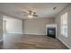 Open-concept living room with hardwood floors, a cozy fireplace, and ample natural light at 201 Coral Cir, Mcdonough, GA 30253