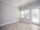 Bright dining area featuring a modern chandelier, neutral paint and door to the exterior at 2544 Castellan Dr, Atlanta, GA 30316