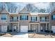 Inviting townhome showcasing a brick exterior, private balconies, and well-maintained landscaping at 2544 Castellan Dr, Atlanta, GA 30316