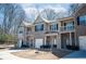 Desirable townhome with brick accents, quaint balconies, and attached garages on a tree-lined street at 2544 Castellan Dr, Atlanta, GA 30316