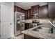 Well-equipped kitchen featuring stainless steel appliances, granite countertops, and dark wood cabinets at 2544 Castellan Dr, Atlanta, GA 30316