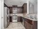 Spacious kitchen featuring stainless steel appliances, granite countertops, and ample dark wood cabinetry at 2544 Castellan Dr, Atlanta, GA 30316
