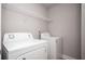 Functional laundry room with white appliances and shelving at 2544 Castellan Dr, Atlanta, GA 30316
