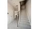 Well-lit foyer with a carpeted staircase and detailed wainscoting adding a touch of elegance at 2544 Castellan Dr, Atlanta, GA 30316