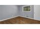 Cozy bedroom with hardwood floors, natural light from the window, and neutral-colored walls at 2675 Davidson Dr, Lithonia, GA 30058