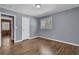 Well-lit bedroom featuring hardwood floors and neutral walls at 2675 Davidson Dr, Lithonia, GA 30058