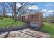 Brick home with a driveway and a stone retaining wall at 2675 Davidson Dr, Lithonia, GA 30058
