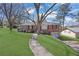 Charming one-story brick home boasts a lush front lawn and a paved walkway at 2675 Davidson Dr, Lithonia, GA 30058