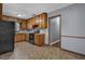 Kitchen featuring wood cabinets, black appliances, and tile floors at 2675 Davidson Dr, Lithonia, GA 30058