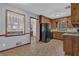 View of kitchen featuring black refrigerator and view through doorway to carpeted bonus room at 2675 Davidson Dr, Lithonia, GA 30058